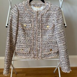 A cropped boucle jacket with fray detail.